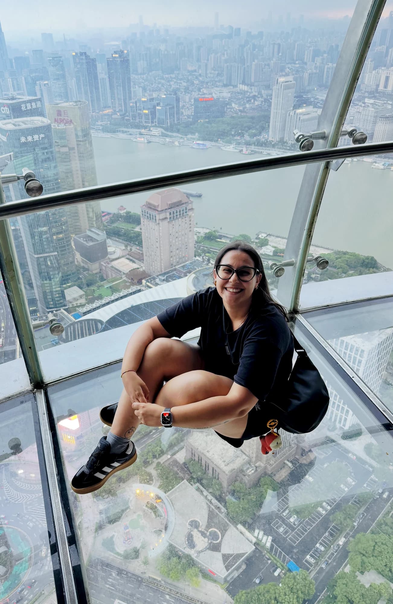 Erika Leoni sul pavimento di vetro della Oriental Pearl Tower, con Shanghai sotto di lei